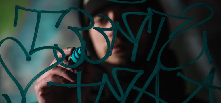 selective-focus-of-man-writing-graffiti-with-marke-4YWWSFB.jpg
